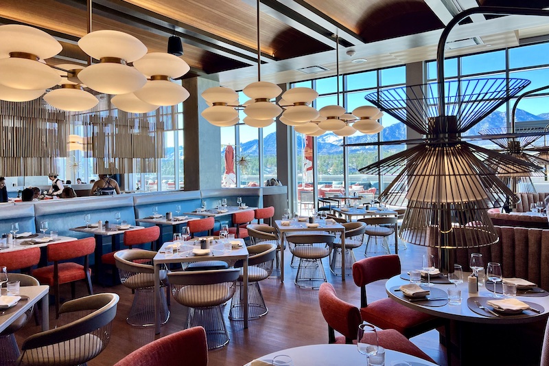 Midcentury modern decor and mountain views through the large windows of Pamela's restaurant at Hotel Polaris.