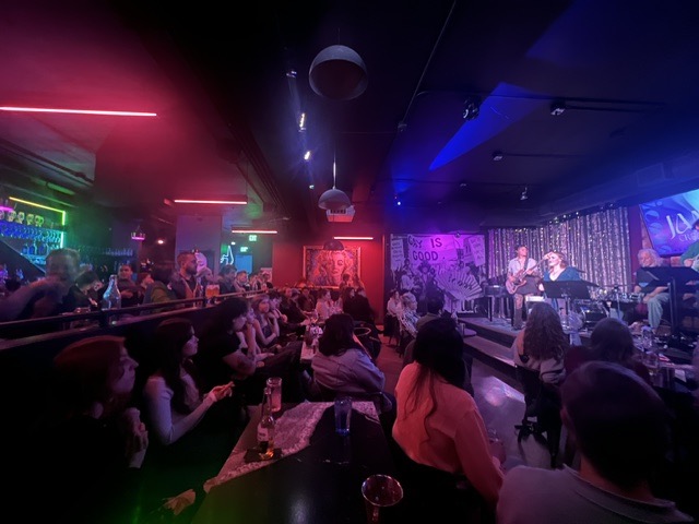 A full crowd at Icons nightclub as singers perform on stage. 