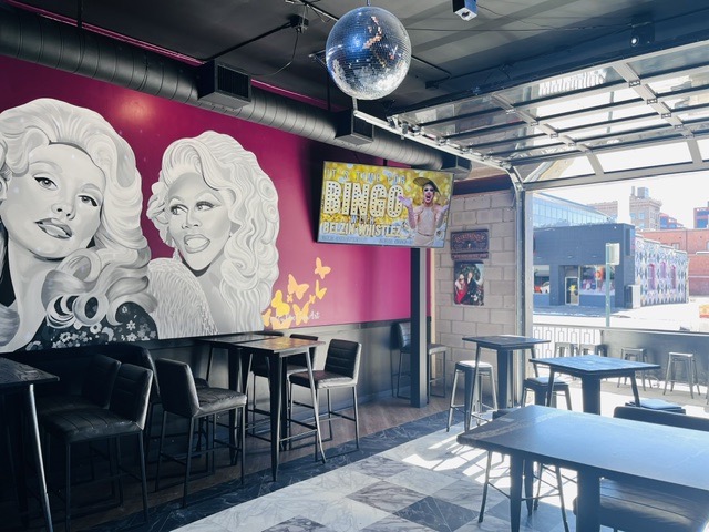 View of wall art and view through the front patio at Icons gay bar in Colorado Springs.