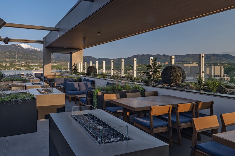City and mountain views from the rooftop patio at Lumen8, one of the most scenic restaurants with a view in Colorado Springs.