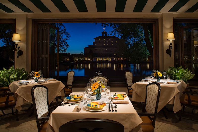 The Broadmoor Hotel lights reflect in the lake in the view from Ristorante Del Lago.