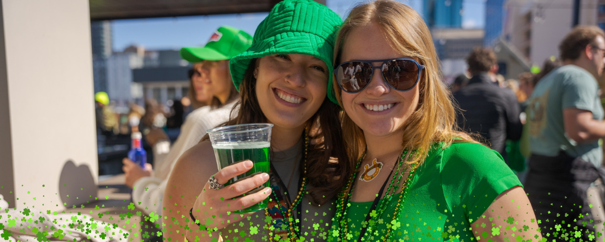 Two girls celebrate during St. Patrick's Day pub crawl in Colorado Springs.