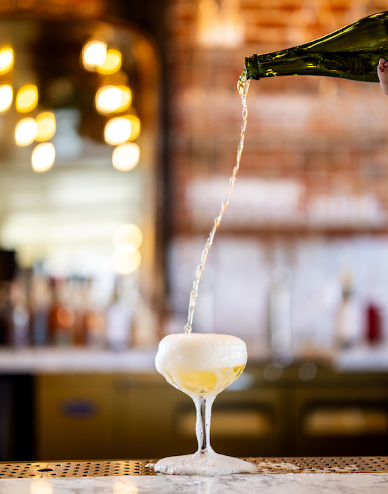 Champagne pours at Golden Hour to toast the new Mining Exchange Hotel restaurant: Oro.