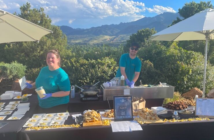 The Blue Star Group's Whitney Symington serves food at an outdoor event.