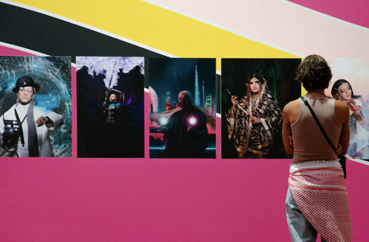 A woman views a vibrant photography exhibition at the Colorado Springs Fine Arts Center.