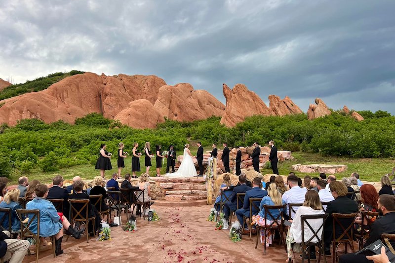 A wedding ceremony among the red rock outcroppings at the Flying W Ranch, one of the most scenic wedding venues in Colorado Springs.