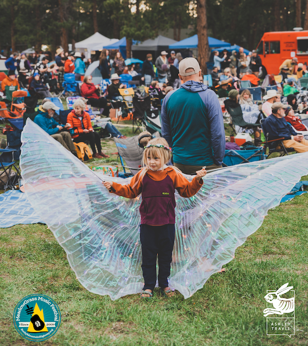 A little girl with fairy wings dances at the MeadowGrass Music Festival in Colorado Springs.