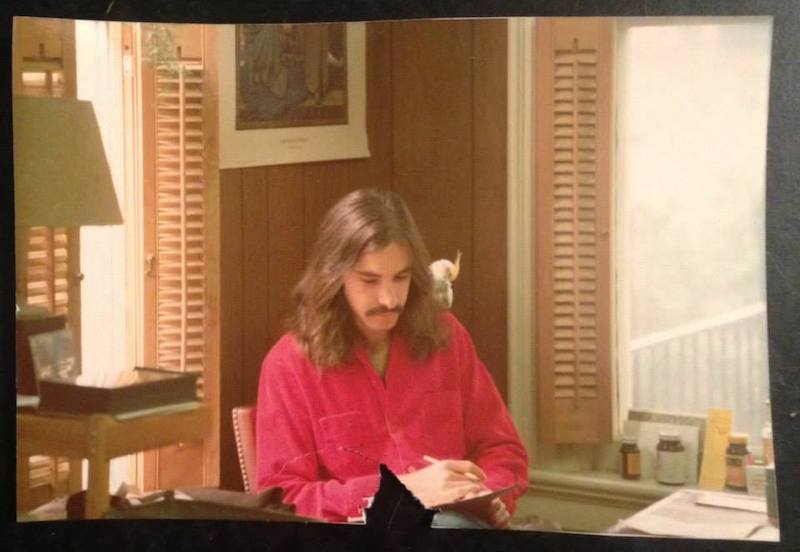 Richard Skorman (and pet cockatiel) in his first Poor Richard's Bookstore in 1975.