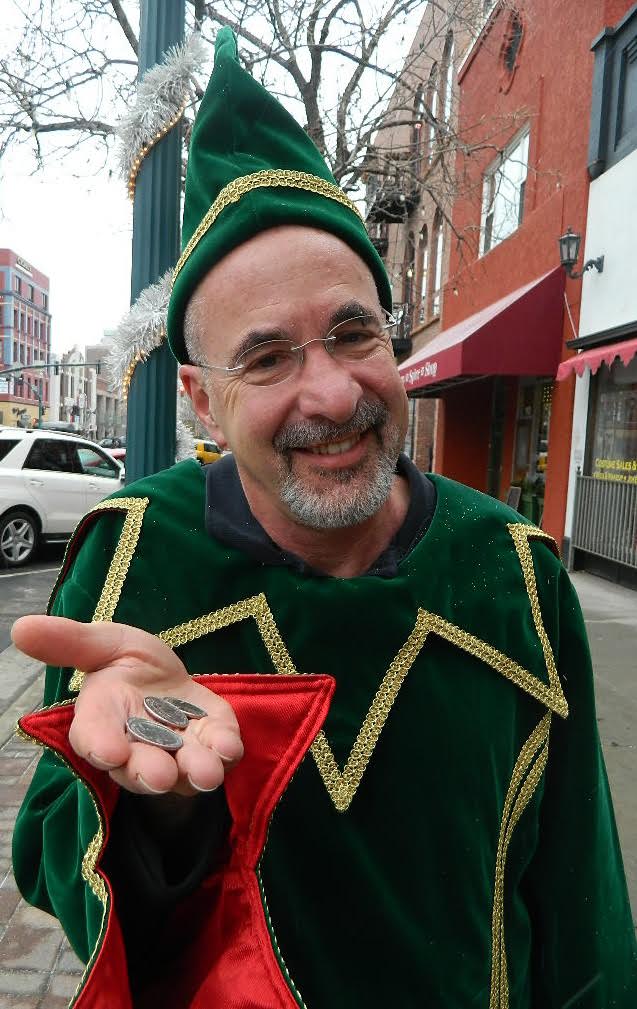 Richard Skorman in his parking elf costume, paying parking meters in downtown Colorado Springs during the holidays.