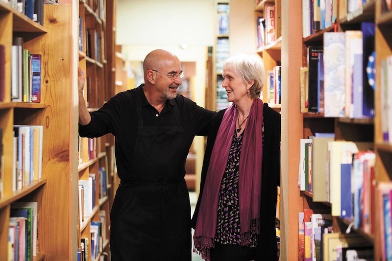 Richard Skorman and Patricia Seator, owners of Poor Richard's in Colorado Springs, face each other among the bookshelves at Poor Richard's Books and Gifts.