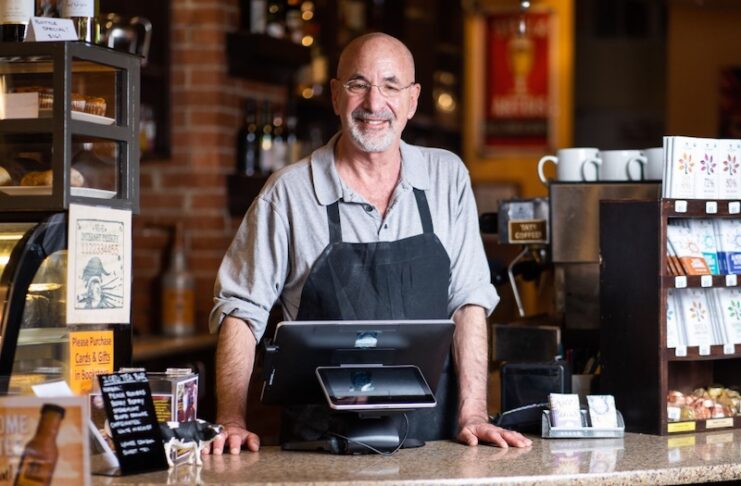 Owner Richard Skorman behind the counter at Rico's Cafe, part of the Poor Richard's Downtown complex of small businesses.
