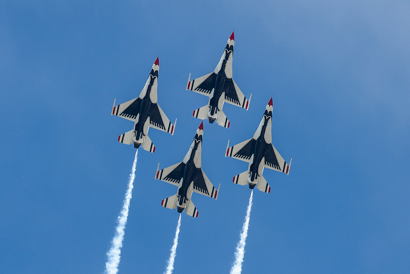 Four Thunderbirds F-16 Flying Falcon jets fly in a diamond formation.