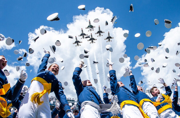 U.S. Air Force Academy cadets throw their caps as the Thunderbirds fly over at the Academy graduation ceremony.