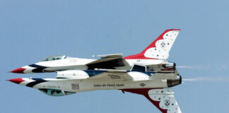 Two Thunderbirds F-16 Fighting Falcon jets fly in mirror image precision.