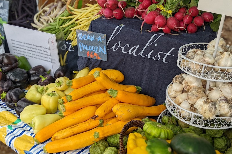 Fresh vegetables and a Localist t-shirt at the Backyard Farm Market in Black Forest.