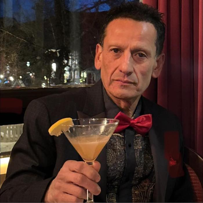 Carlos Echeandia raises a cocktail.
