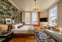 A corner king room with historic brick wall, hardwood floors and stylish finishes, all amenities that make the Mining Exchange Hotel one of the best hotels in Colorado Springs.