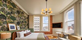 A corner king room with historic brick wall, hardwood floors and stylish finishes, all amenities that make the Mining Exchange Hotel one of the best hotels in Colorado Springs.