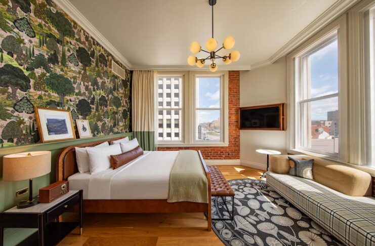 A corner king room with historic brick wall, hardwood floors and stylish finishes, all amenities that make the Mining Exchange Hotel one of the best hotels in Colorado Springs.