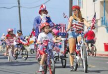 Kids ride bikes in the Monument July 4 Parade.