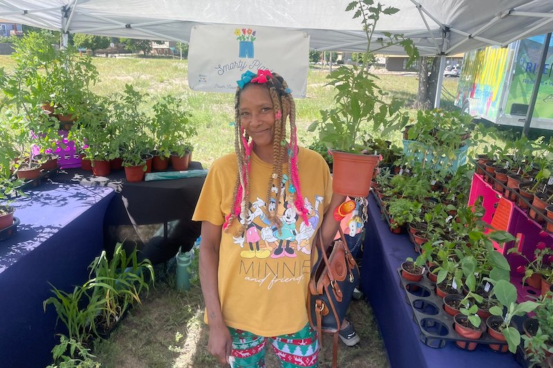 A woman shops for plants at the Southeast Farmers Market in Colorado Springs.