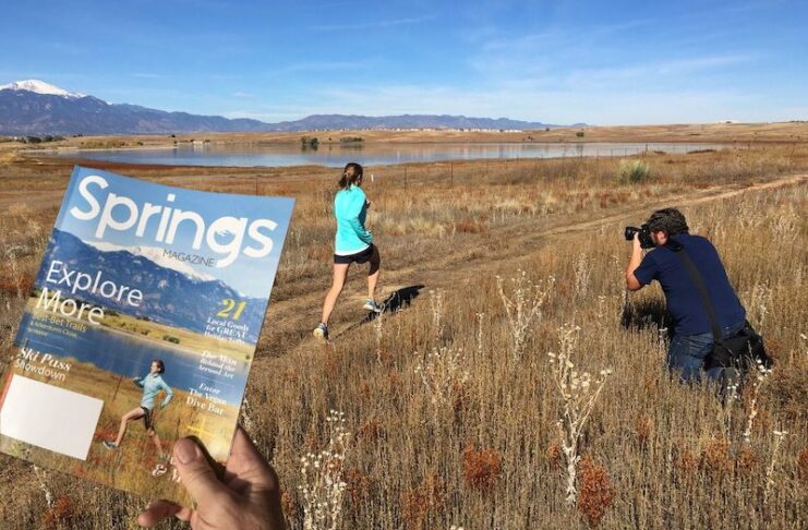 Behind the scenes view of the first cover shoot for Springs magazine showing Bryan Oller photographing Mary Baldwin at Blue Stem Prairie Open Space on the east side of Colorado Springs with Pikes Peak in the background.