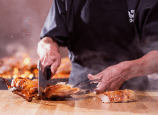 El Pollo Loco Chef cuts up grilled chicken from El Pollo Loco.