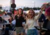 Taste of Pikes Peak Serves Up a New Venue Two women wave with excitement at Taste of Pikes Peak, the Colorado Springs food festival of the year