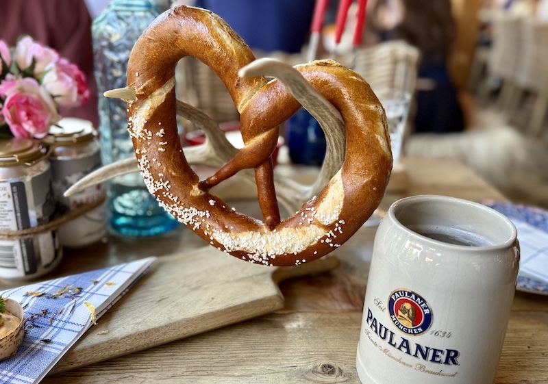 A fresh-baked pretzel hangs from an antler and a stein of Paulaner beer at Alpenhouse, a favorite authentic Bavarian restaurant in Vail.