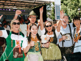 Where to Celebrate Oktoberfest 2026 in Colorado A group in lederhosen and dirndl cheer at Oktoberfest in Breckenridge Colorado