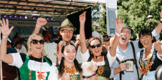 A group in lederhosen and dirndl cheer at Oktoberfest in Breckenridge Colorado
