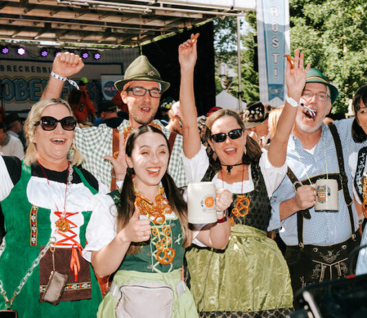 Where to Celebrate Oktoberfest 2026 in Colorado A group in lederhosen and dirndl cheer at Oktoberfest in Breckenridge Colorado