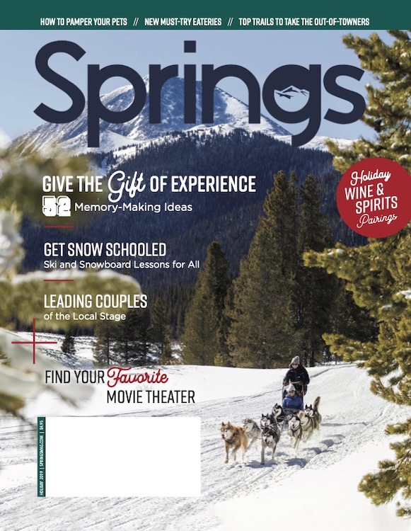 Dogsledding in the mountain near Breckenridge on the cover of Springs magazine.