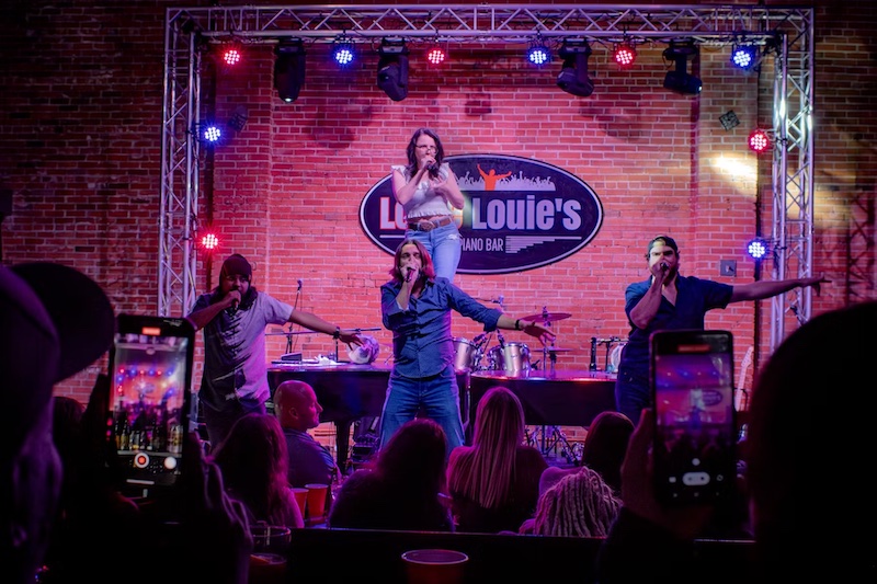 Performers on stage at Louie Louie's, one of the most unique places to eat in Colorado Springs.