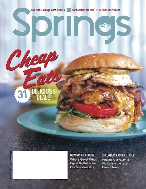 A big burger from the Green Line Grill on the cover of Springs magazine.