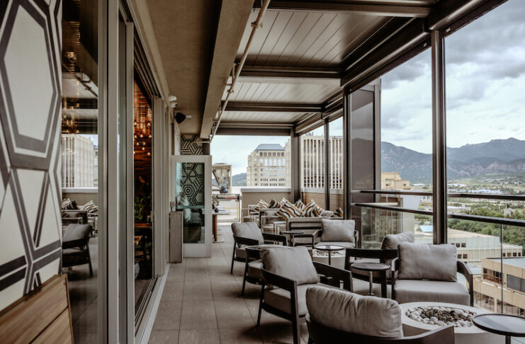 City skyline and mountain views on the rooftop patio at Ryze Skyline Lounge in downtown Colorado Springs.