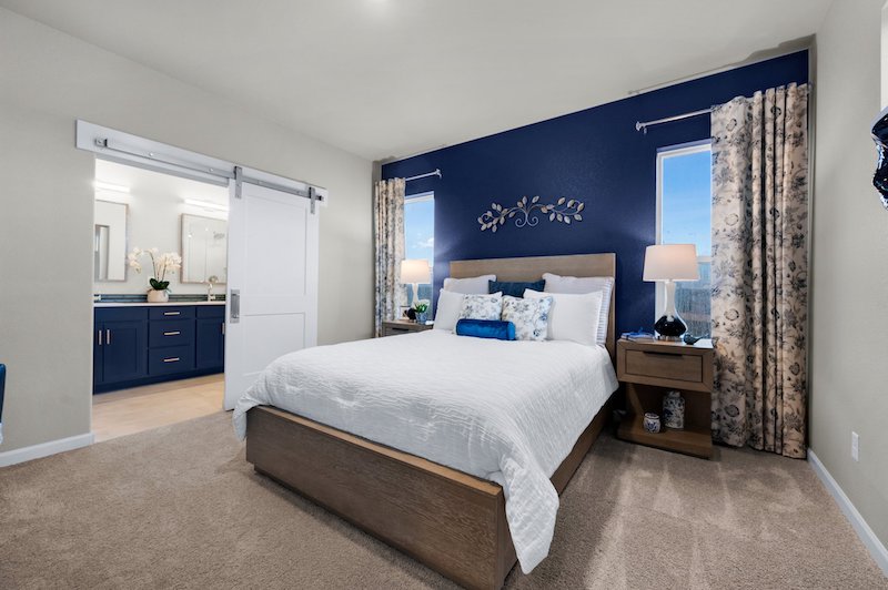 The primary bedroom in the Derby Cottage model home by Vanguard Homes at Gold Hill Mesa.