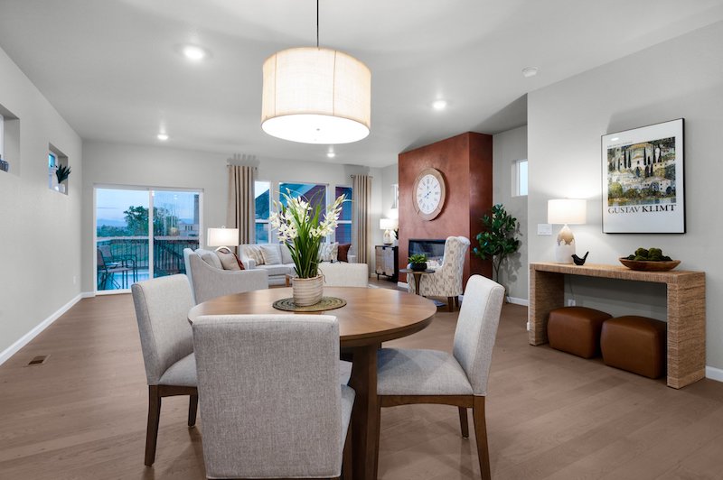Inside view of the dining room and great room in the Derby Cottage model home by Vanguard Homes at Gold Hill Mesa.