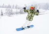 A snowboarder celebrates at Opening Day of Arapahoe Basin. Will A Basin be the first Colorado ski resort to open for the season?