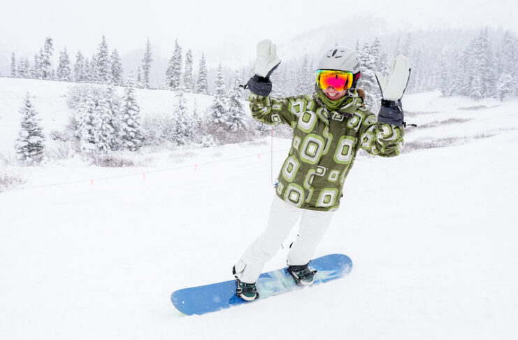 A snowboarder celebrates at Opening Day of Arapahoe Basin. Will A Basin be the first Colorado ski resort to open for the season?