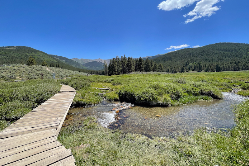 Wooden bridge over the creek on the trail to Tincup Cemetery in Colorado.