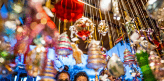 Woman and child enjoy festive holiday decorations during Christkindl Market.