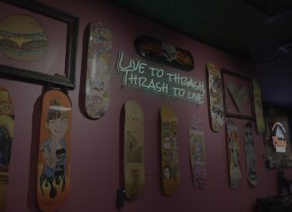 Thrashers Skateboards and neon sign inside Thrashers, a new dive bar in Colorado Springs