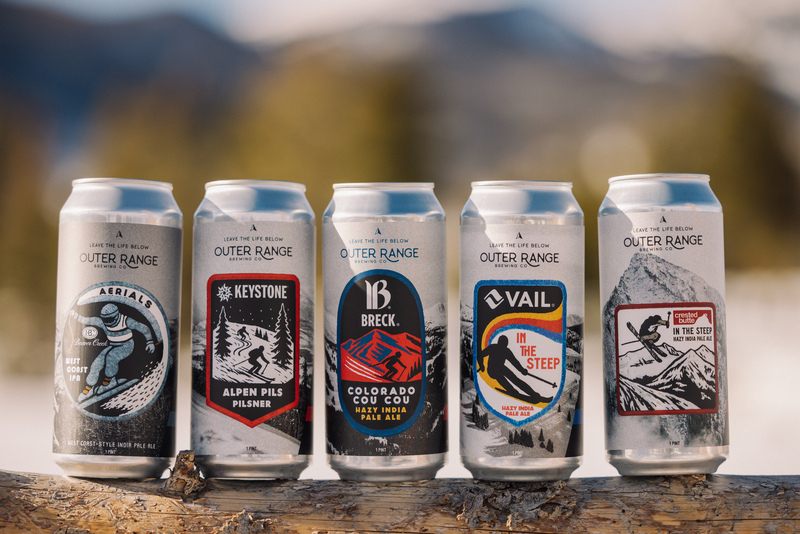 A row of partner beer cans by Outer Range Brewing and Vail Resorts. 