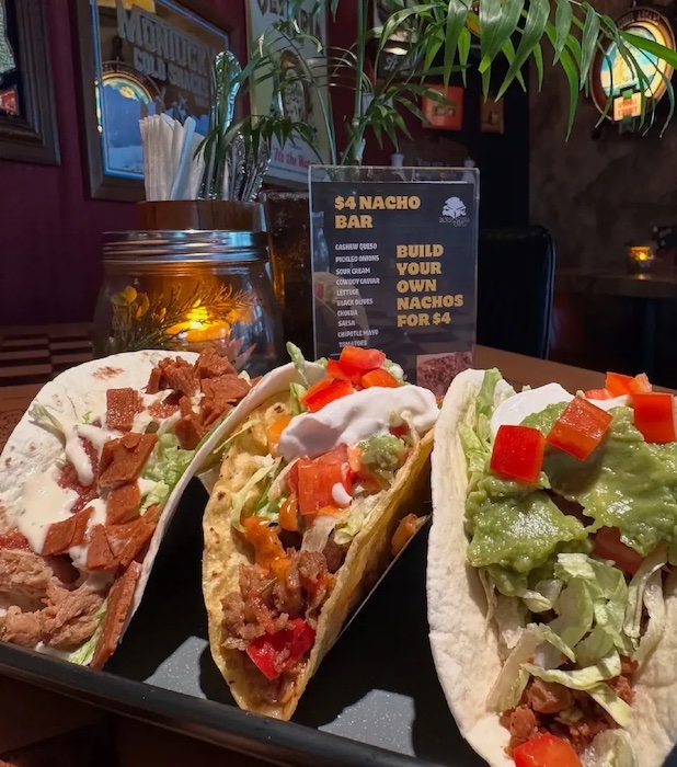 Vegan tacos and a sign for $4 Nacho Bar at the Burrowing Owl, one of the best cheap eats in Colorado Springs.