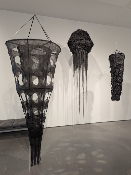 Hanging art in The Source Never Diminishes exhibition by artist Nina Elder at GOCA at the Ent Center for the Arts.