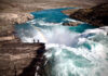 Kayakers stand in front of a raging waterfall in Baffin Vacation Love on Ice from the Banff Film Festival.