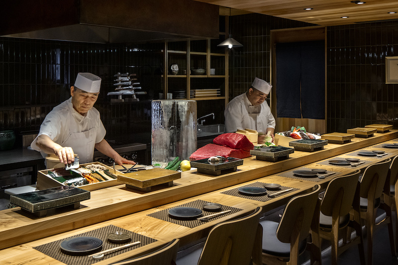 Chef Toshi Kizaki, left, behind the sushi bar at Kizaki, a Michelin Star restaurant in Denver and nominee for Best New Restaurant in the 2026 James Beard Awards in Colorado. 