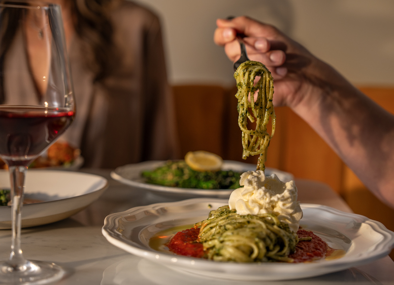 A couple shares pasta and wine at Oro. The restaurant at the Mining Exchange Hotel offers its San Valentino d’Oro for Valentine's Day.