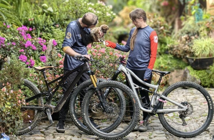 A author and her husband with bikes and a puppy on a mountain biking adventure trip with Endure Adventures.